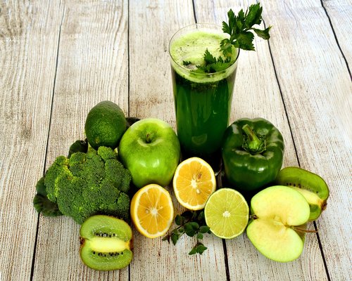 Fresh green smoothie and fruits